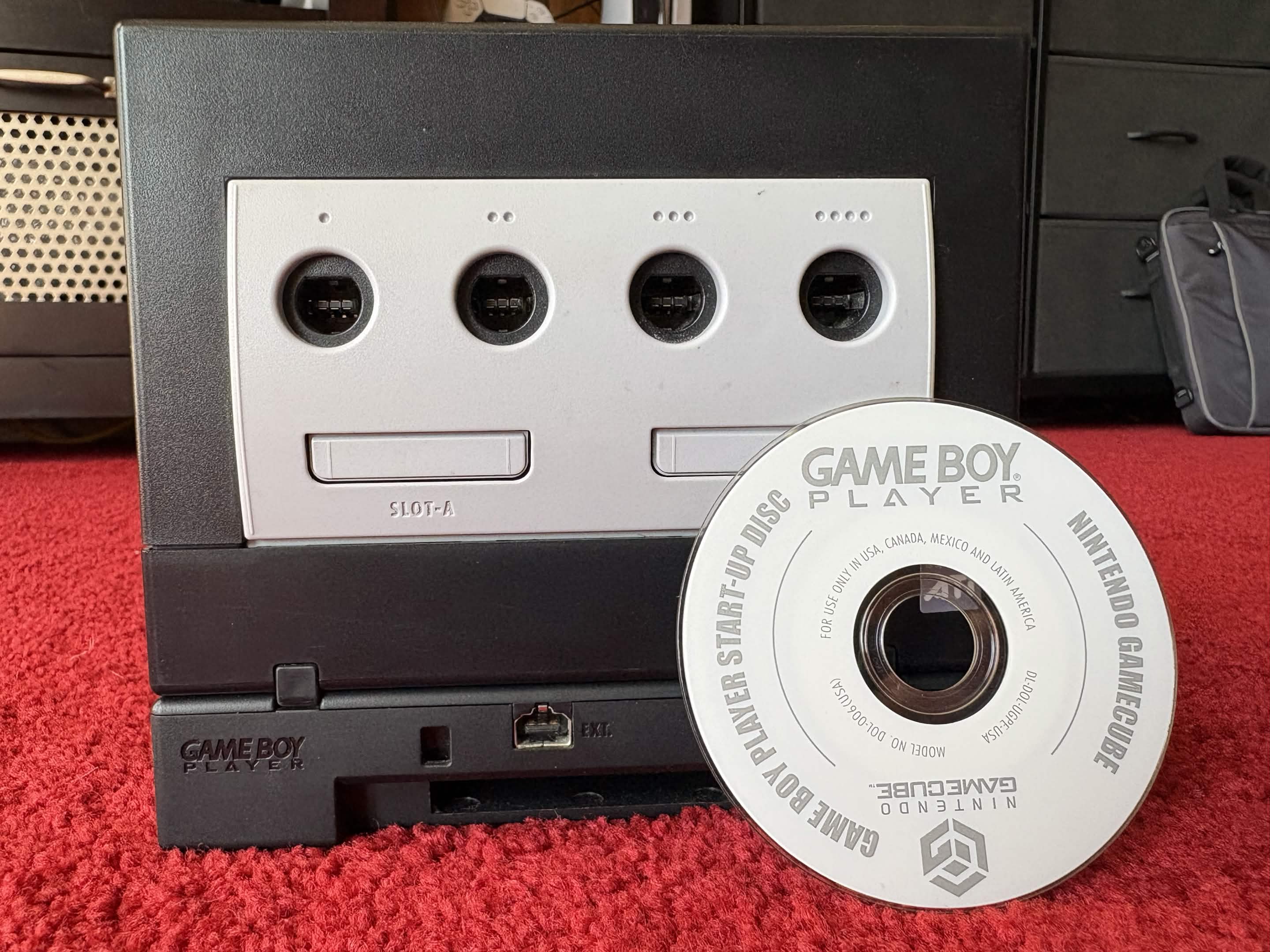 A photo of a Game Boy Player and disc