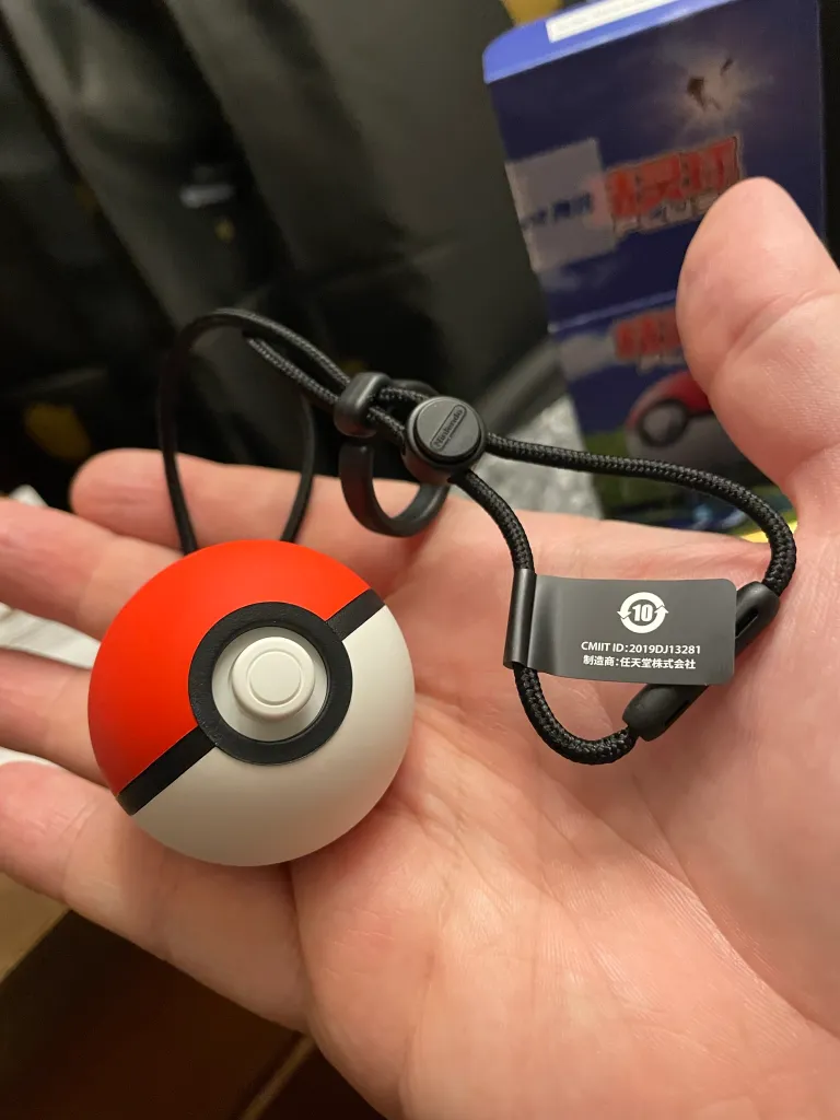 A photo of a Poké Ball Plus device