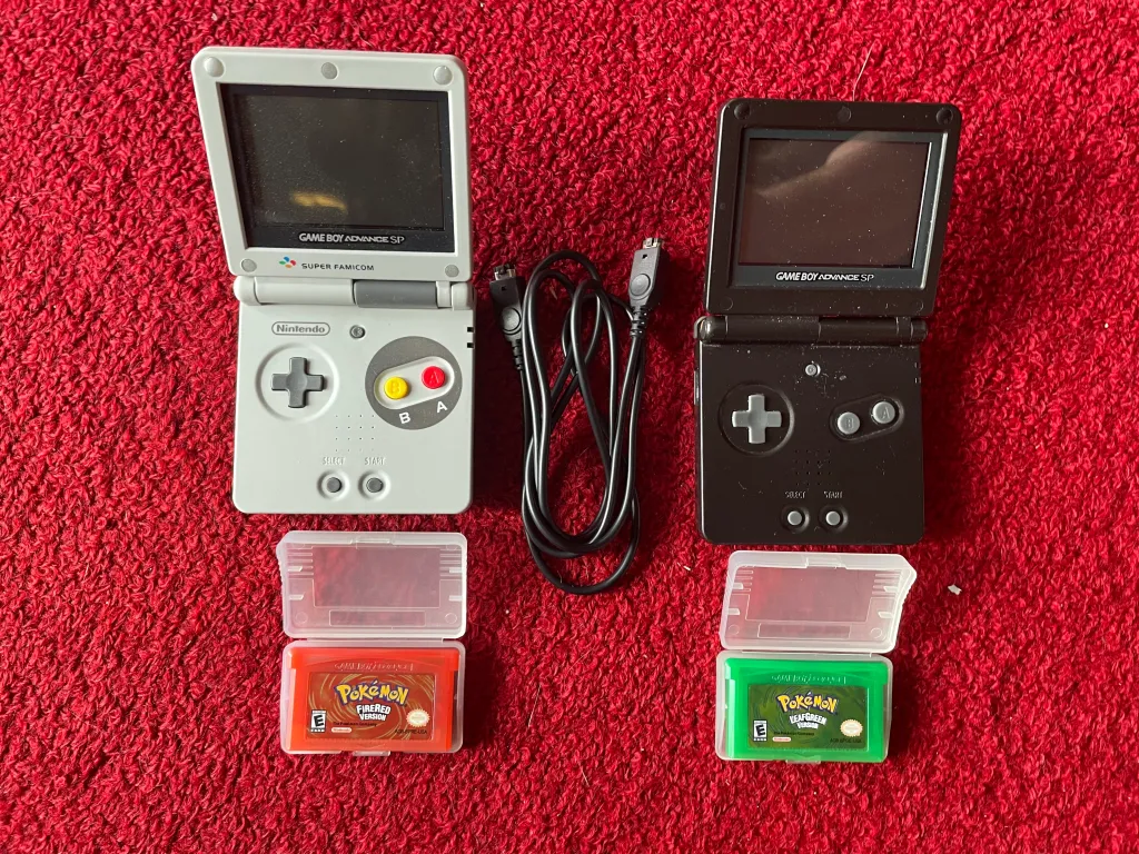 Two reproduction game cartridges with two Game Boy Advance consoles